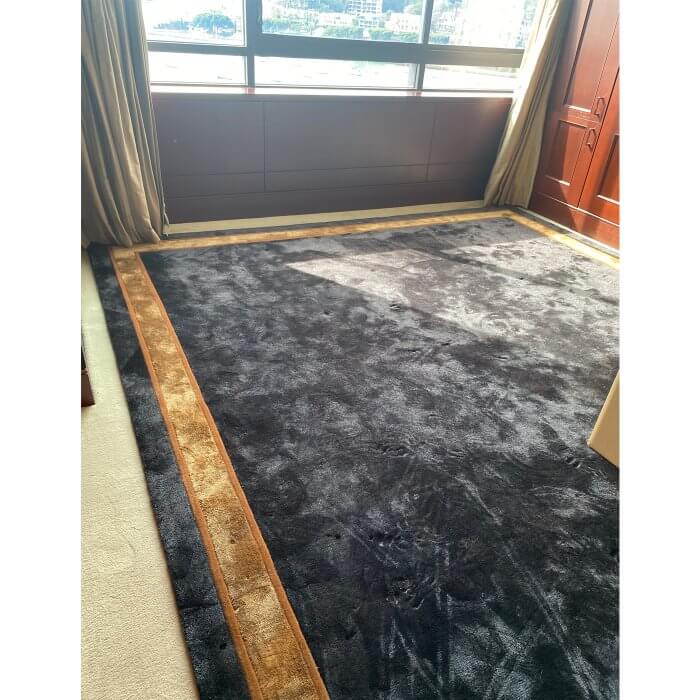 Black rug with caramel border